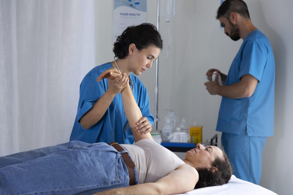 Atient lying on bed with medical staff checking shoulder replacement surgery