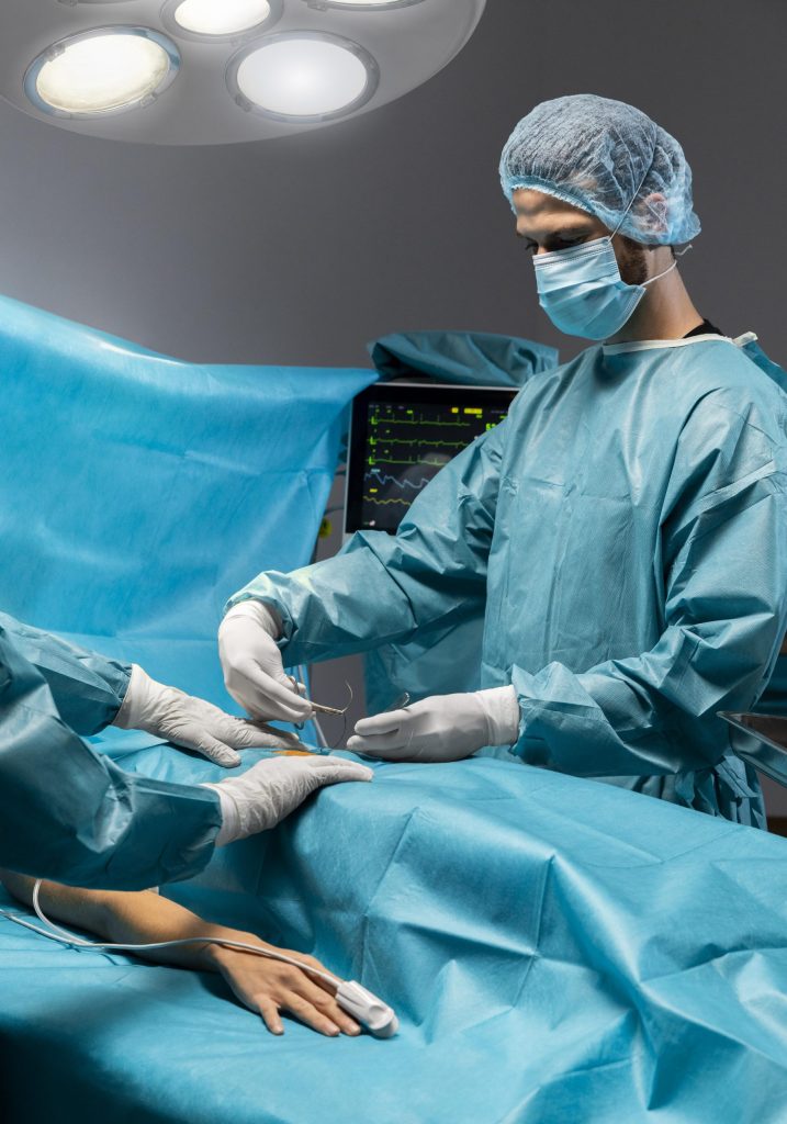 Surgeons performing hip replacement surgery in an operating room